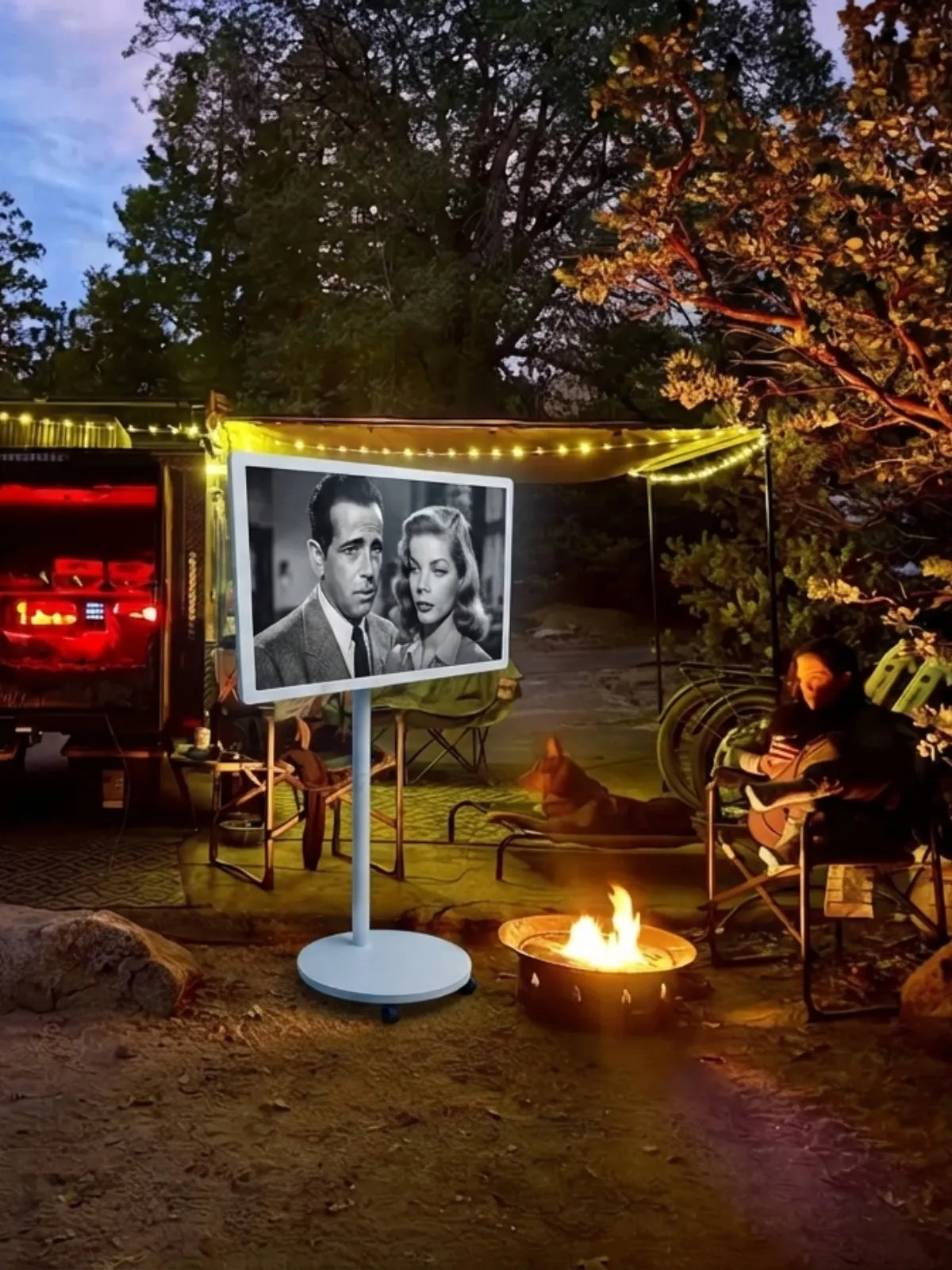 watching a movie on the portable smart touch screen tv at the campsite