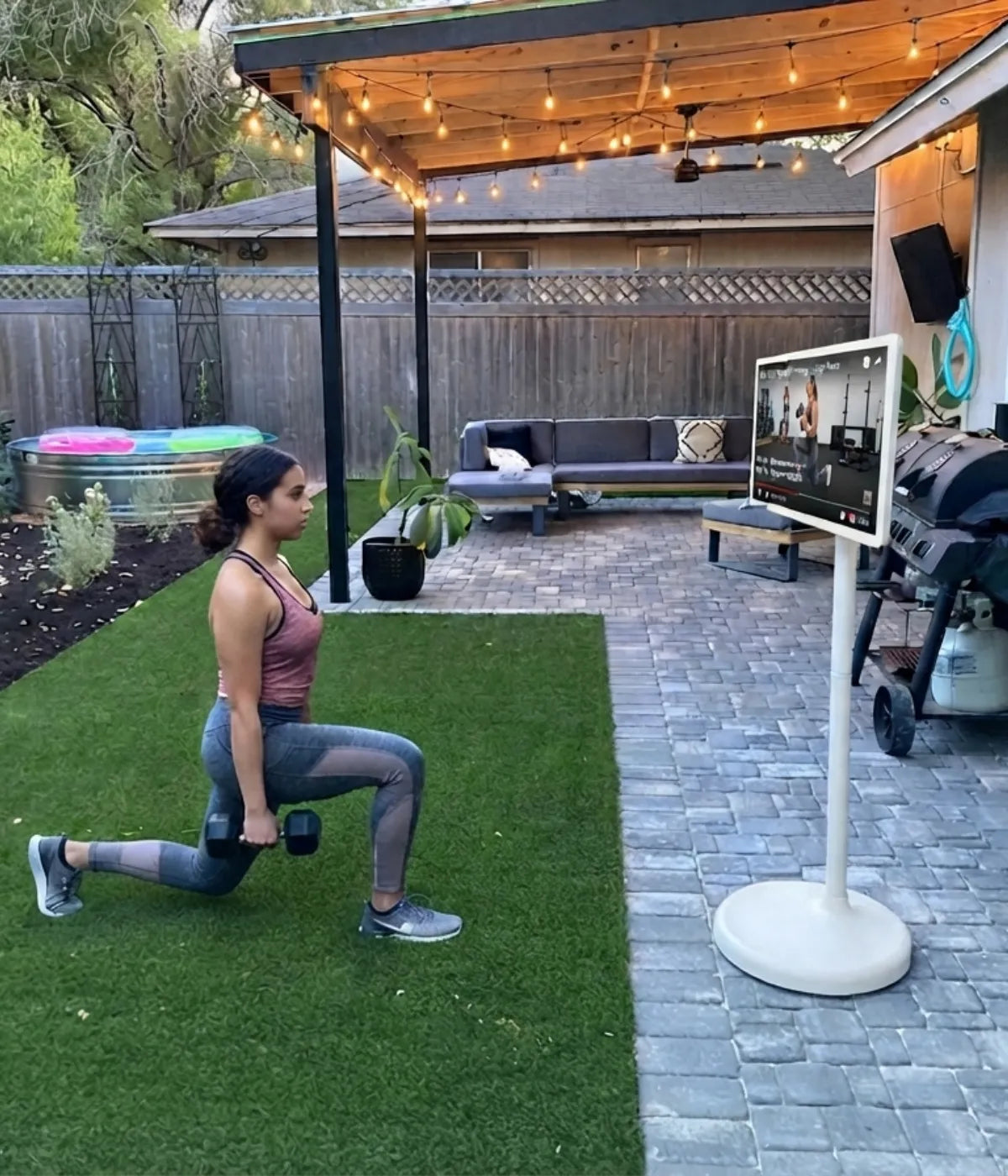 Strength training with a portable TV on wheels