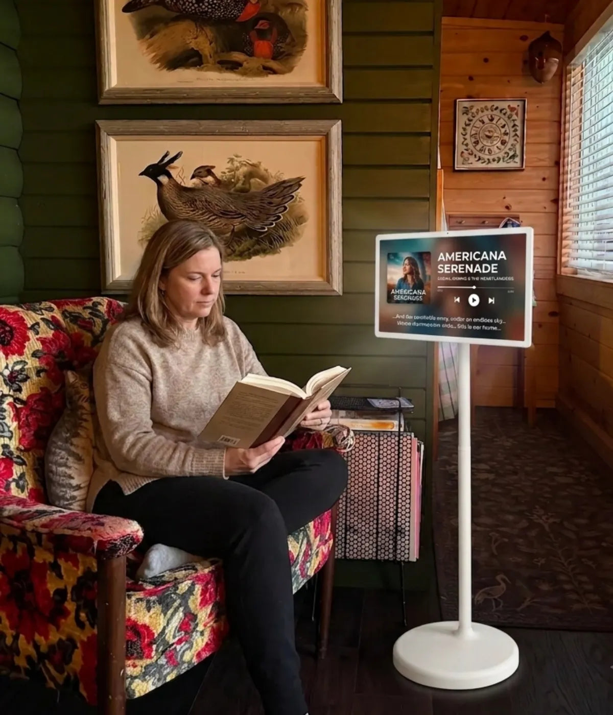 A woman is reading quietly, while the GFF portable smart screen beside her is playing a podcast